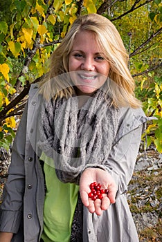 Happy woman who offers lingonberry