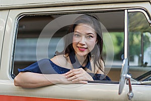 Happy woman at window of vintage van