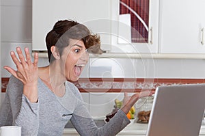 Happy woman winning internet auction game