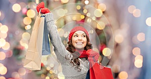 Happy woman in winter clothes with shopping bags