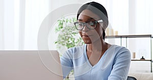 Happy woman working on laptop at office