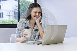 Happy woman working at the office with cups of coffee. businesswoman drinking coffee