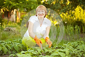 Happy woman working in vegetable garden