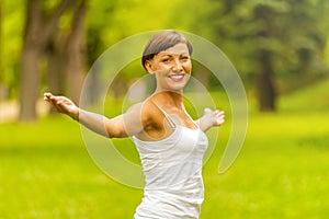 Happy woman in wreath outdoors summer enjoying life opening hand