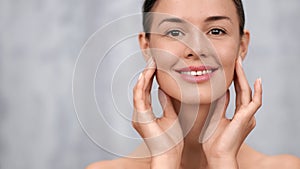 Happy woman with wrinkles on face applying anti aging cream. Medium close up shot on 4k RED camera