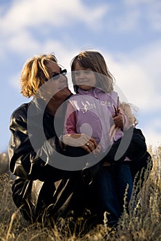 Happy woman with young girl in sun