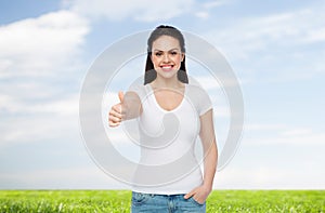 Happy womanin white t-shirt showing thumbs up