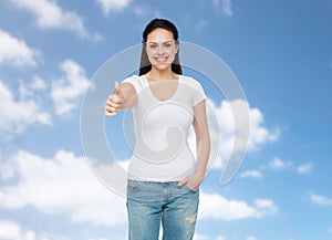 Happy womanin white t-shirt showing thumbs up