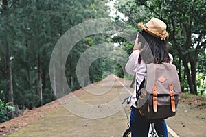 Happy women backpacker with shooting in nature background