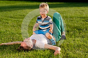 Happy woman and child having fun outdoor on meadow