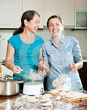 Happy women cooking dumplings