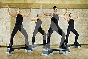 Happy women exercising in the fitness club