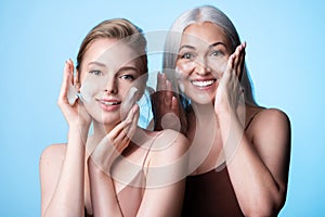 Happy women  generations applying cleansing foam