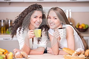 Happy women with the morning cups of tea