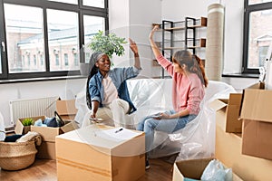 happy women moving to new home and counting money