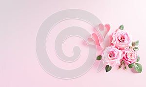 Happy Women`s Day concept. Top view of roses flower with heart on pink pastel background