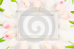 Happy Women`s Day, Mother`s Day and Valentine`s Day concept. top view flat lay Tulip flower and photo frame