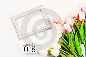 Happy Women`s Day, Mother`s Day and Valentine`s Day concept. top view flat lay Tulip flower and photo frame