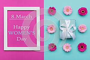 Happy Women`s Day Pastel Candy Colours Background. Floral womens day flat lay with beautifully wrapped present.