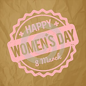 Happy Women`s Day rubber stamp baby pink on a crumpled paper brown background.