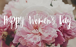 Happy women`s day text on beautiful peony bouquet. Stylish pink and white peonies. Greeting card. 8 march