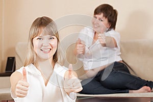 Happy women showing thumb up sign