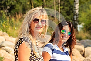 Happy women sun tanning and relaxing on beach.