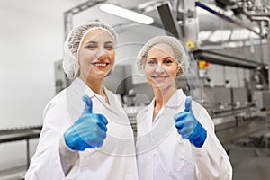 Happy women technologists at ice cream factory