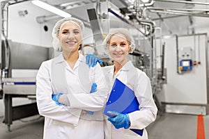 Happy women technologists at ice cream factory