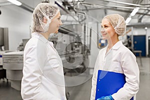 Happy women technologists at ice cream factory