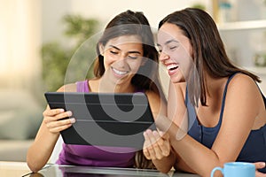 Happy women using tablet at home