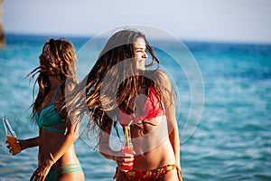 Happy women on vacation having fun on beach in summer