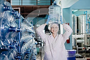 happy women worker working in drinking water plant factory with enjoy work with wate bottle gallon in warehouse with hygiene
