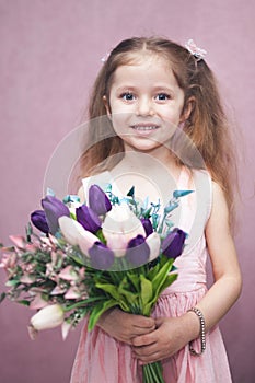 Happy womens day for my mom, little girl holds flowers tulip