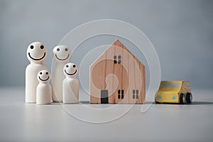 Happy wooden human family figure peg dolls with home and car. Money saving concept to build a family
