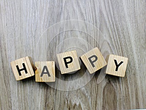 Happy word wooden block on wooden background