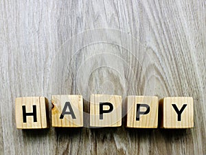 Happy word wooden block on wooden background