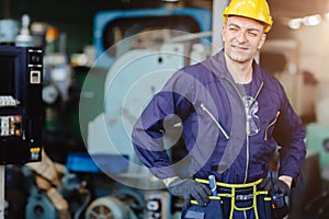 Happy worker.engineer smiling for service maintenance fix machine in heavy industy with safty suit and helmet