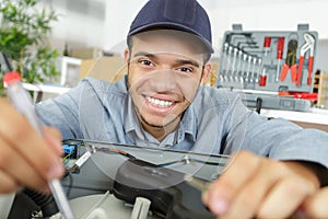 Happy worker fixing machine