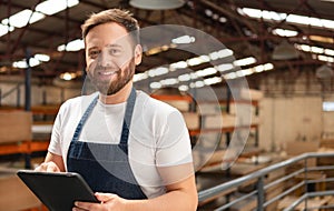 Happy worker looking at camera portrait at warehouse