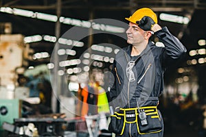 Happy worker, portrait handsome labor with safety suit tools belt and radio service man in factory