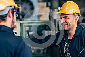 Happy worker, smiling industrial technician engineer enjoy working together with coworker