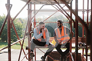 Happy Workers In Construction Site During Lunch Break photo