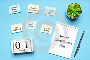 Happy World Compliment Day. Office desk with plant, notebook, pen and paper slips with compliments text for office worker such as