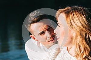 Happy young adult couple enjoying the weekend in the forest in romantic atmosphere. Valentine concept February 14