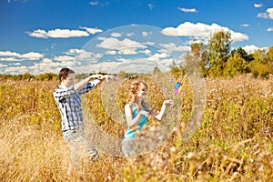 Happy young adult couple in love on the field. Two, man and wom