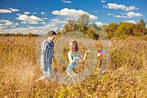 Happy young adult couple in love on the field. Two, man and wom