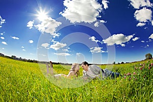 Happy young adult couple in love on the field. Two, man and wom