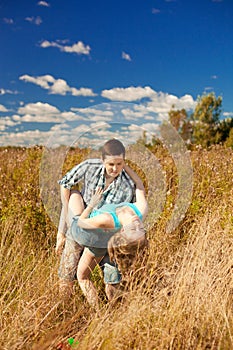 Happy young adult couple in love on the field. Two, man and wom