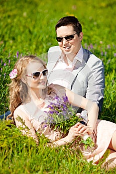 Happy young adult couple in love on the field. Two, man and wom